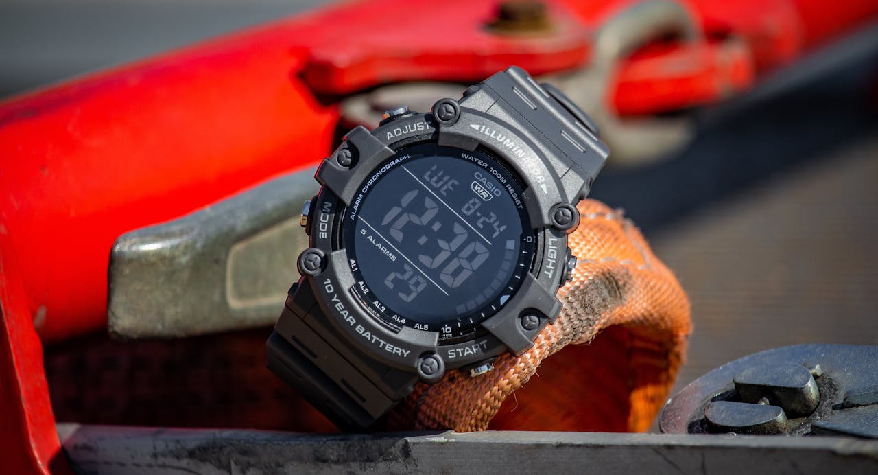 services-03 Close-up of a digital wristwatch on an industrial surface with selective focus.